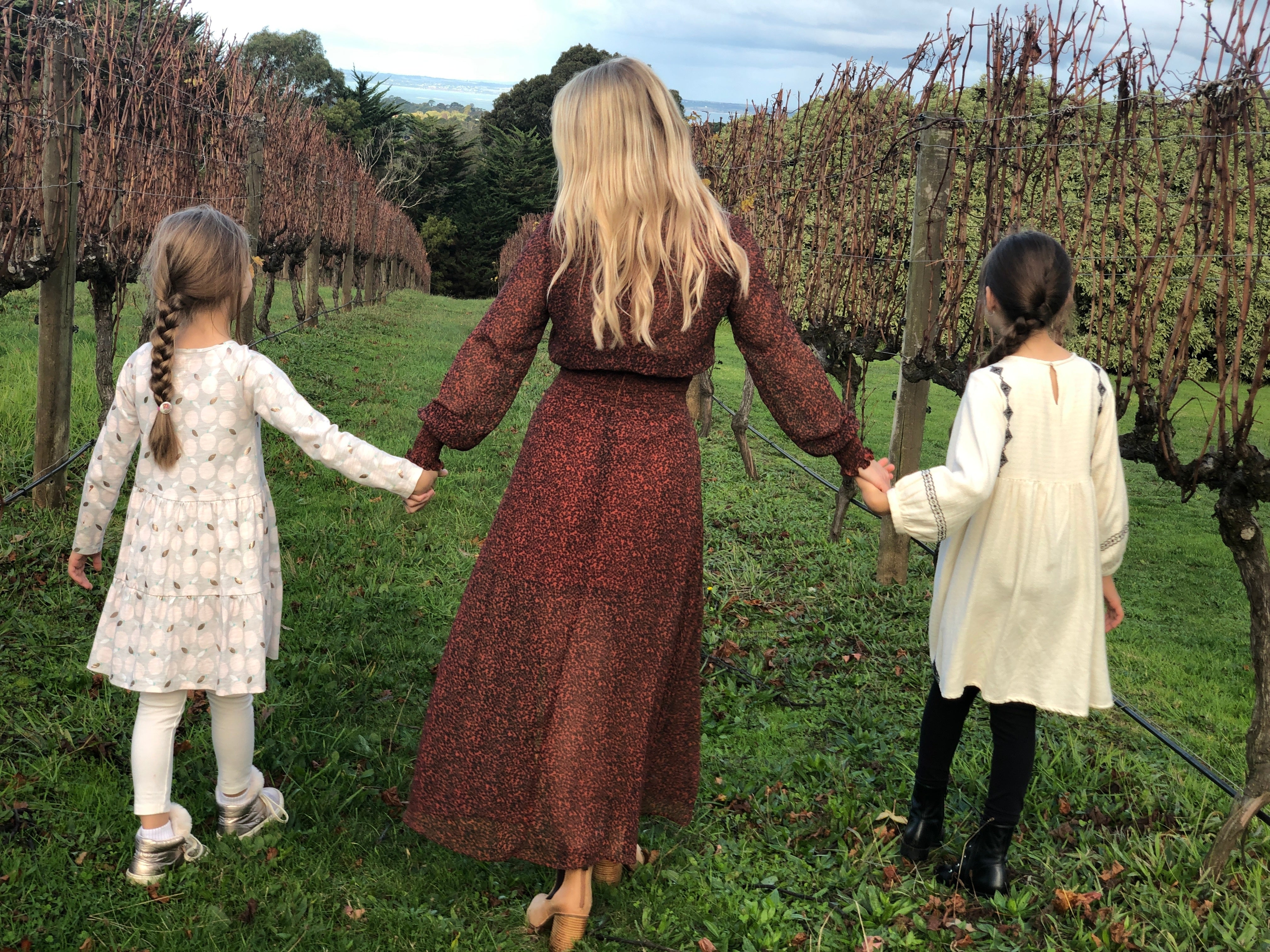 files/woman-and-girls-walk-grassy-path.jpg